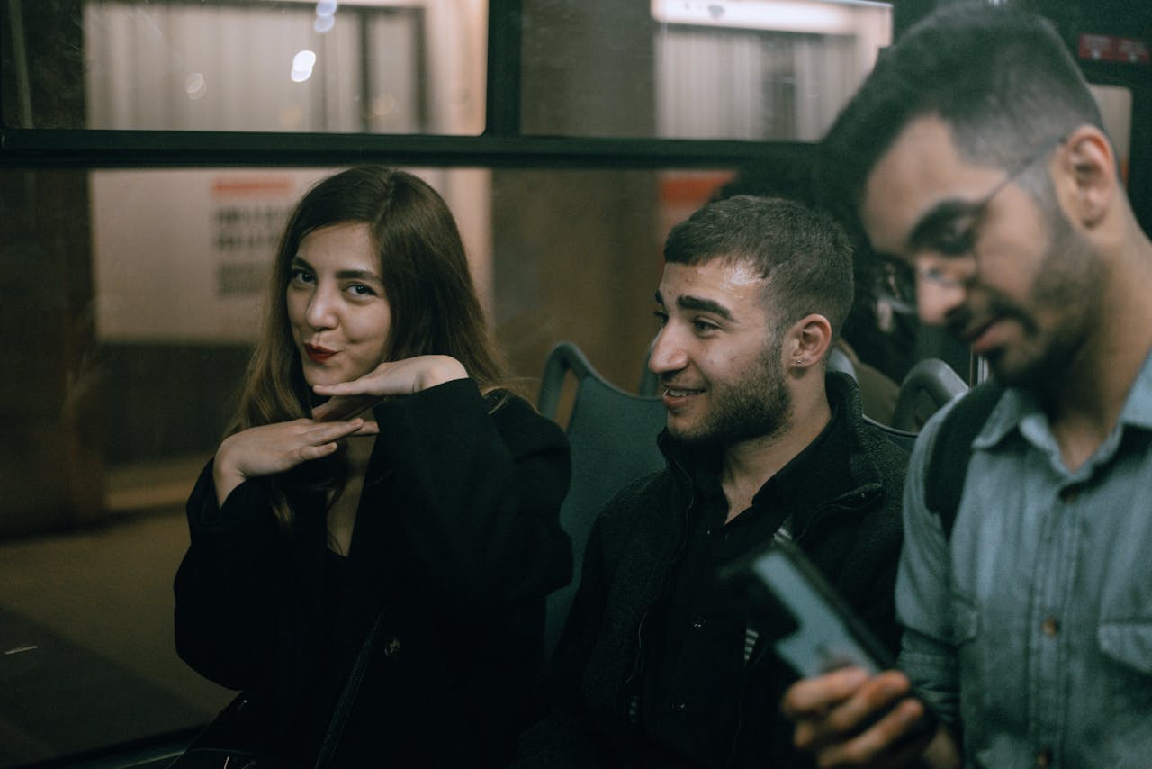 A group of friends enjoying a casual evening bus ride in Genoa, Italy.