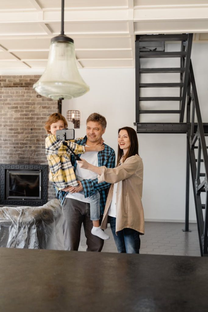 A cheerful family enjoys their new modern loft apartment, capturing the moment on camera indoors.